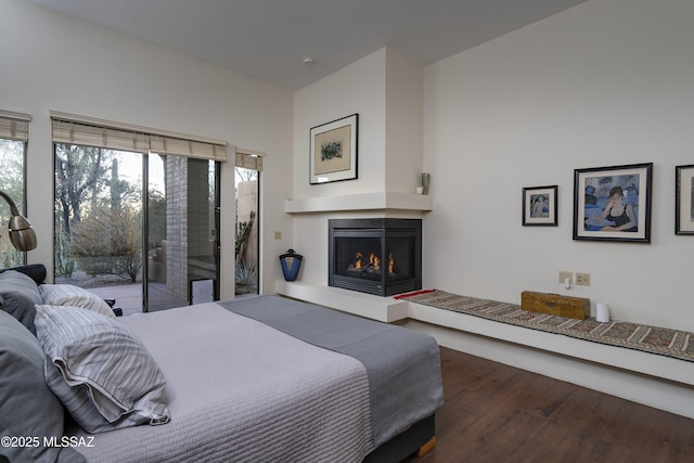 bedroom featuring access to outside and dark hardwood / wood-style floors