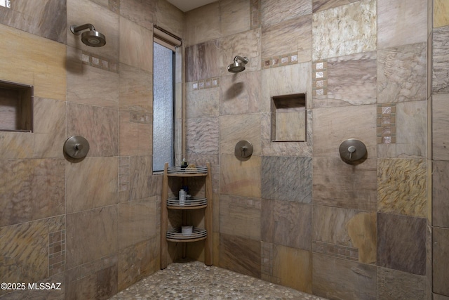 bathroom with a tile shower