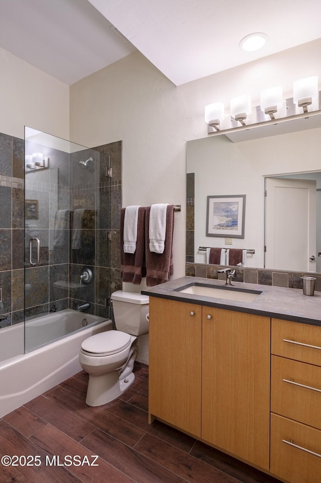 full bathroom with vanity, toilet, and tiled shower / bath combo