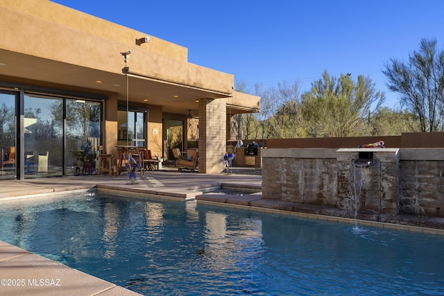 view of swimming pool with a patio area and exterior bar