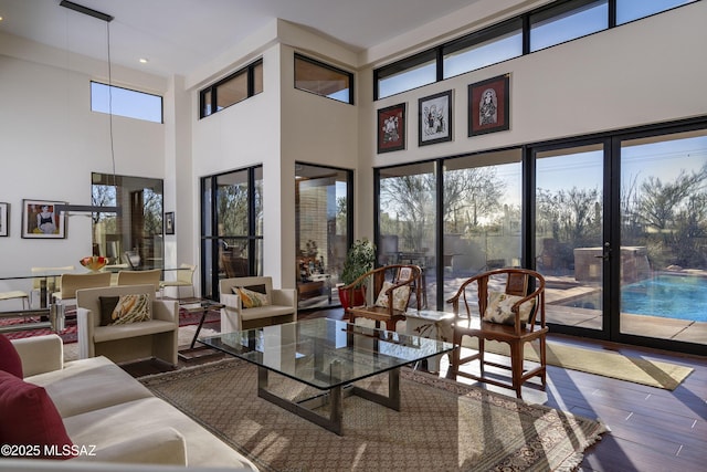 interior space featuring a towering ceiling and plenty of natural light