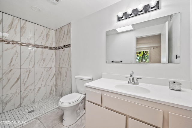 bathroom featuring visible vents, a shower stall, toilet, and vanity