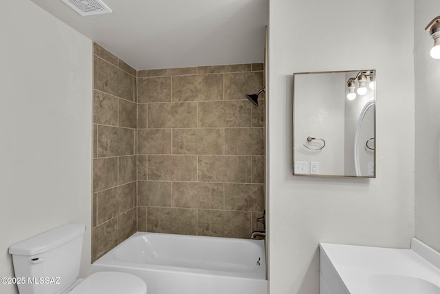 full bathroom featuring vanity, toilet, and tiled shower / bath