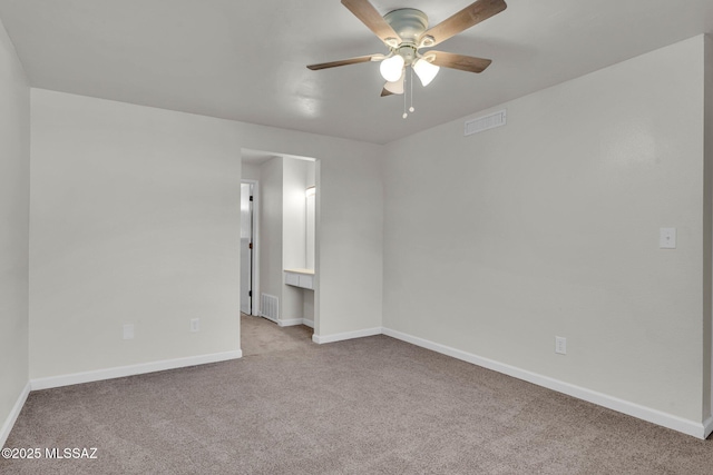 carpeted empty room featuring ceiling fan