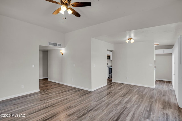 unfurnished living room featuring ceiling fan and light hardwood / wood-style flooring