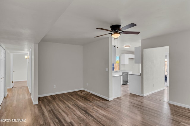 unfurnished living room with ceiling fan and dark hardwood / wood-style flooring