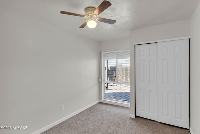 unfurnished bedroom featuring ceiling fan, carpet floors, and a closet