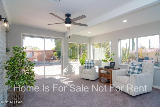 sunroom / solarium featuring beam ceiling, a wealth of natural light, and ceiling fan