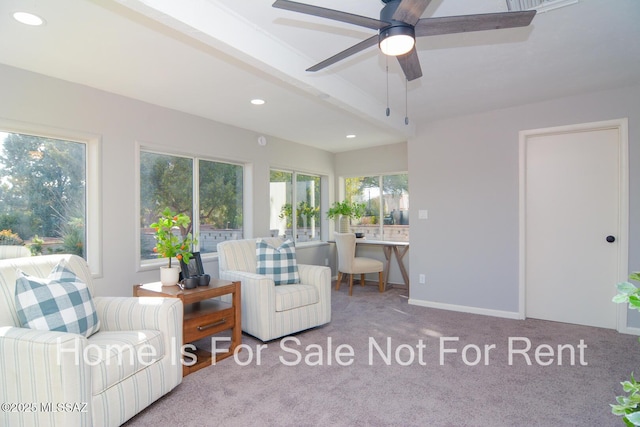 carpeted living room with ceiling fan and beam ceiling