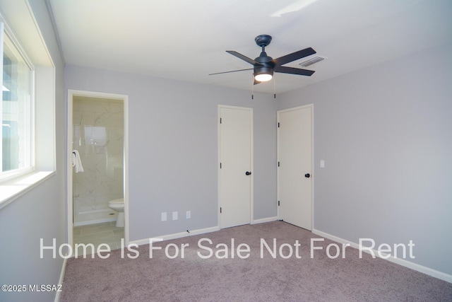 unfurnished bedroom with ensuite bath, ceiling fan, and light carpet