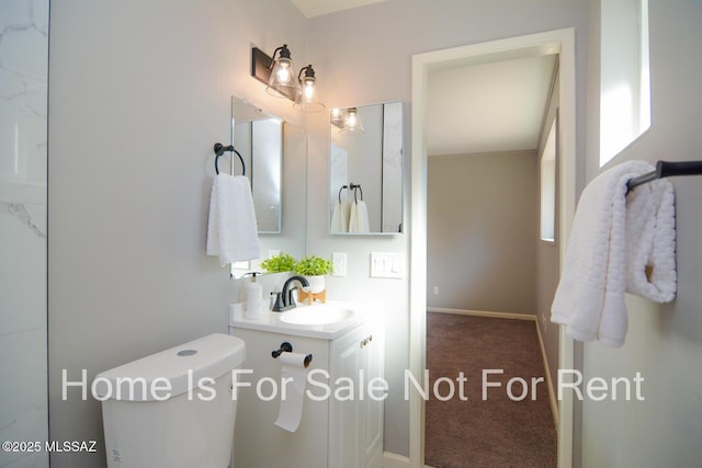 bathroom featuring vanity and toilet