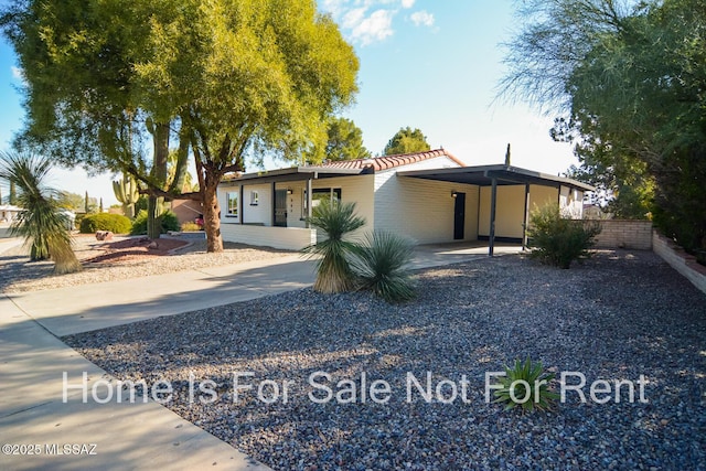 single story home with a carport