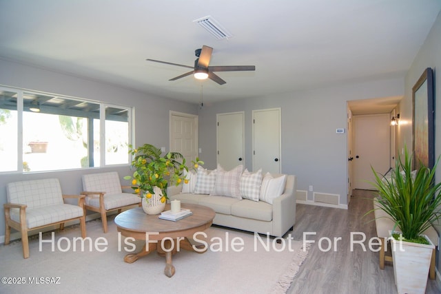 living room with ceiling fan and light hardwood / wood-style floors