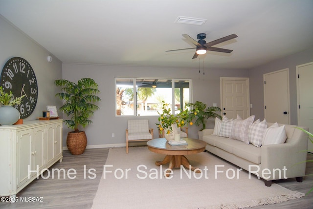 living room with ceiling fan and light hardwood / wood-style flooring