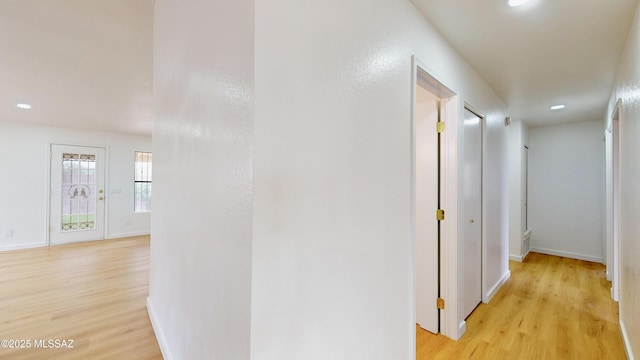 corridor with light hardwood / wood-style flooring