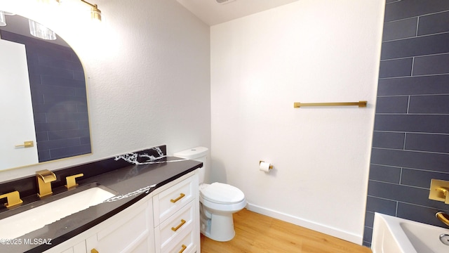 full bathroom with hardwood / wood-style flooring, vanity, toilet, and bathtub / shower combination