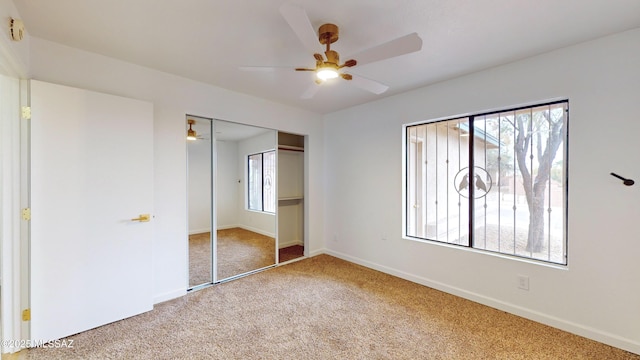 unfurnished bedroom featuring ceiling fan, a closet, and carpet floors