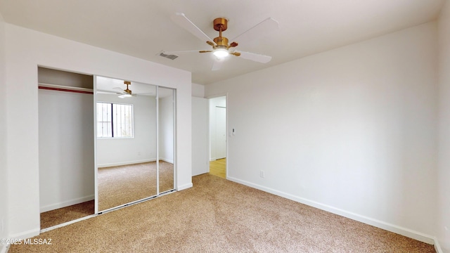 unfurnished bedroom featuring ceiling fan, a closet, and carpet floors