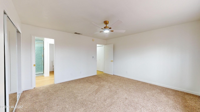 unfurnished bedroom featuring a closet, light colored carpet, and ceiling fan