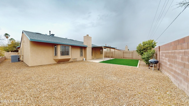 rear view of property with a patio area and central AC