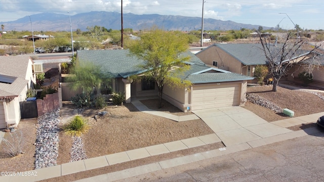 view of front facade with a mountain view and a garage