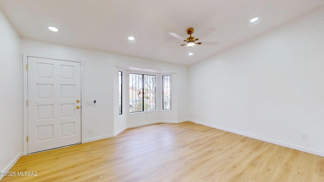 spare room featuring ceiling fan and light hardwood / wood-style flooring