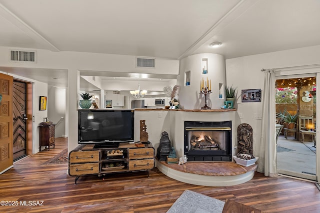 living room with dark wood-type flooring and a chandelier