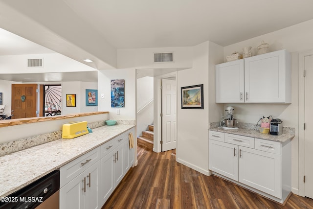 kitchen with white cabinetry, dark hardwood / wood-style floors, light stone countertops, and dishwasher