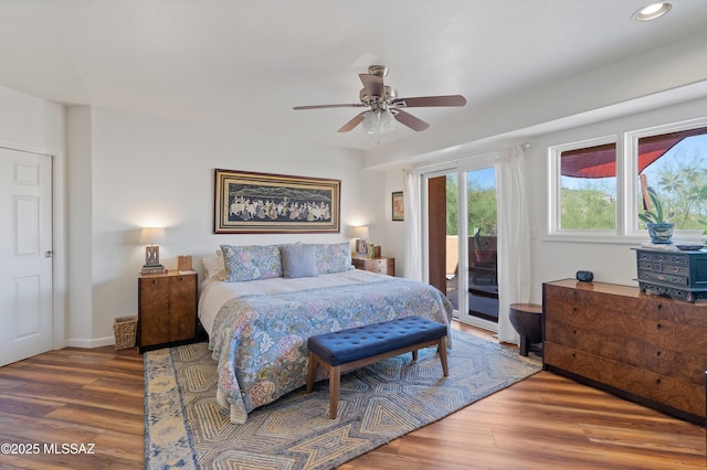 bedroom with wood-type flooring, access to outside, and ceiling fan