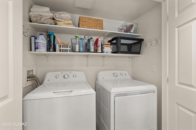 clothes washing area with washer and clothes dryer