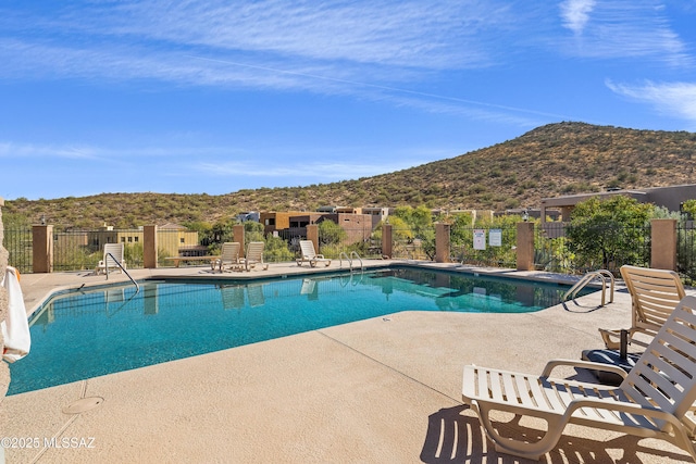 view of pool with a mountain view and a patio area