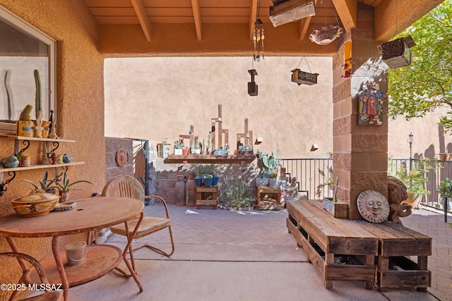 view of patio with exterior fireplace