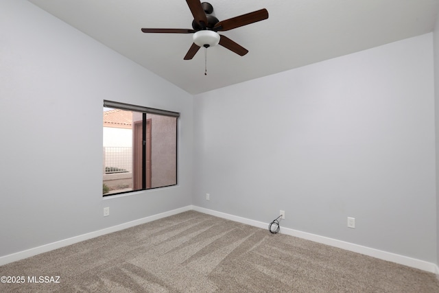 carpeted empty room featuring vaulted ceiling and ceiling fan