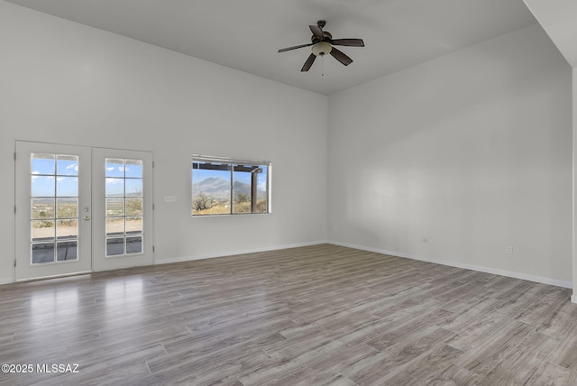 spare room featuring french doors, light hardwood / wood-style flooring, and ceiling fan