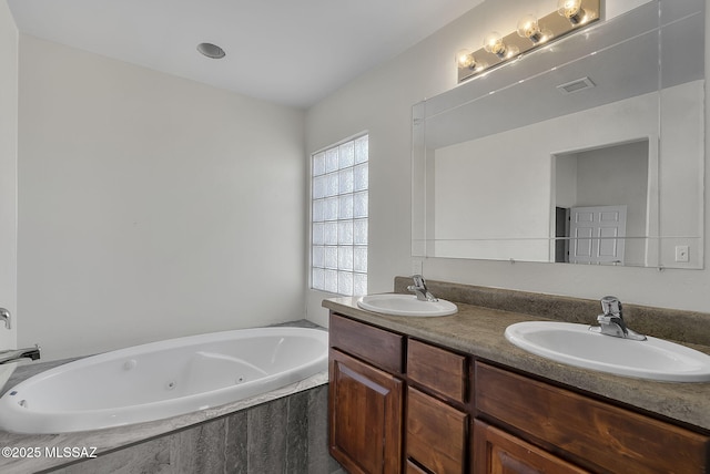 bathroom featuring vanity and tiled tub