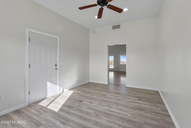 spare room featuring visible vents, baseboards, light wood-style floors, and ceiling fan