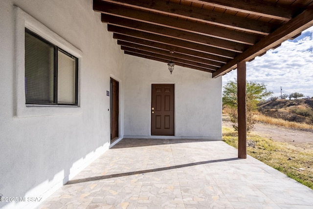 entrance to property featuring a patio