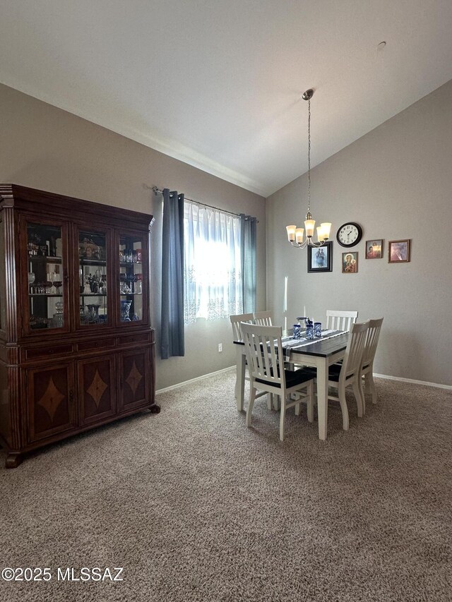 dining area with baseboards, a chandelier, vaulted ceiling, and carpet flooring