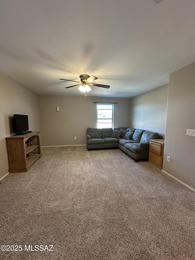 living area featuring carpet, ceiling fan, and baseboards