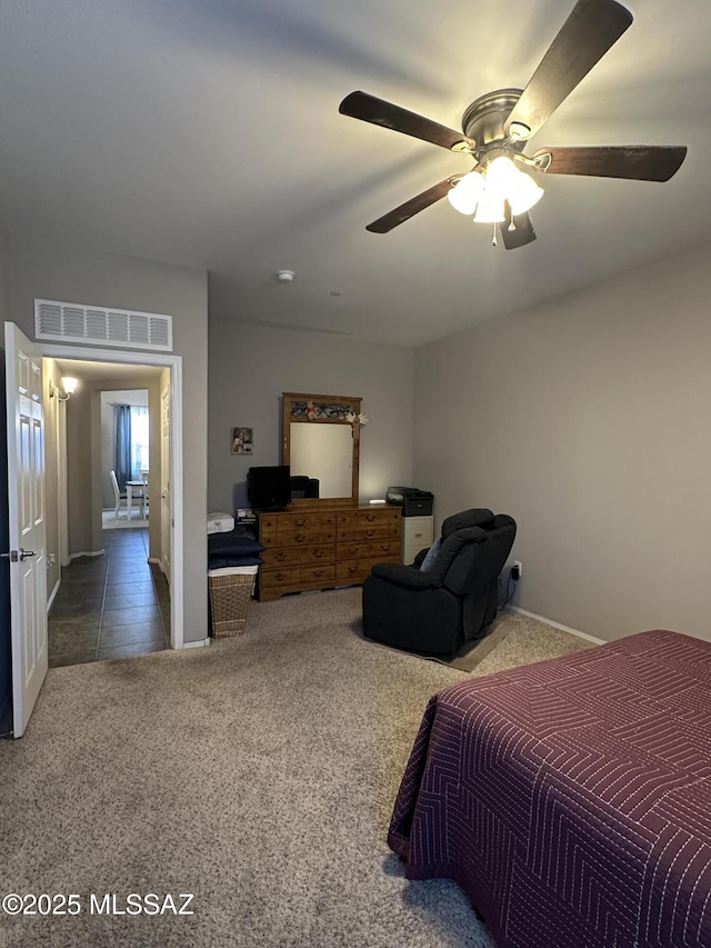 carpeted bedroom with visible vents and a ceiling fan