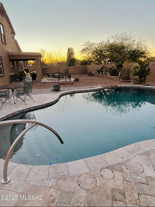 view of swimming pool featuring a fenced in pool, a fenced backyard, and a patio