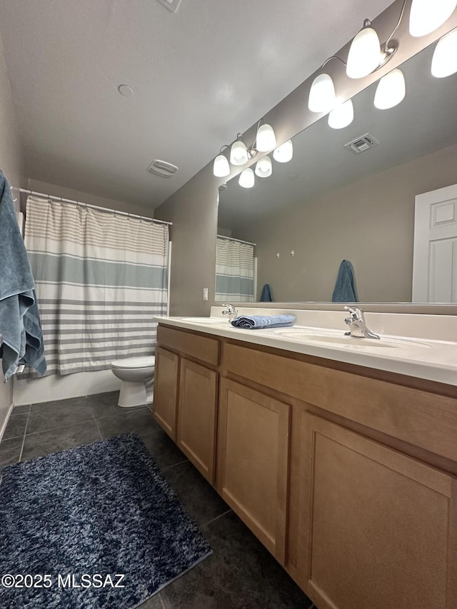 full bath with double vanity, visible vents, toilet, tile patterned floors, and a sink