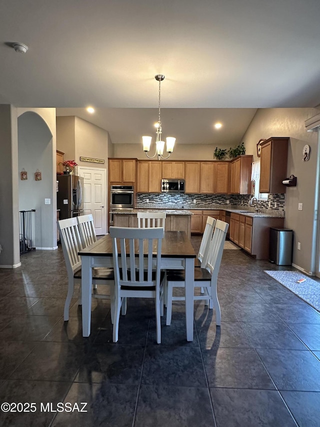 dining space with baseboards, recessed lighting, and an inviting chandelier