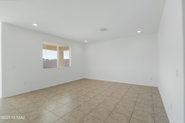 unfurnished room featuring light tile patterned floors