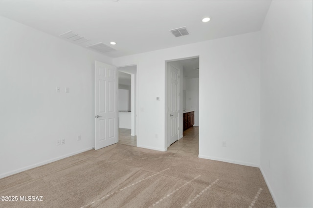 unfurnished room with light carpet