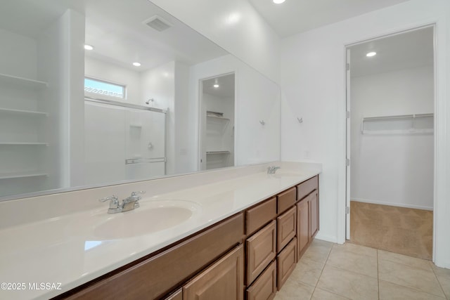 bathroom with vanity, tile patterned floors, and a shower with shower door