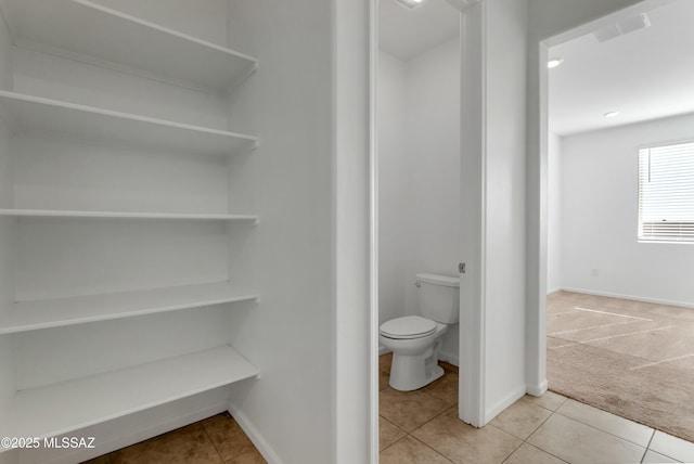 bathroom featuring tile patterned floors and toilet