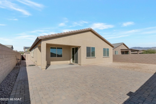 back of house with a patio area