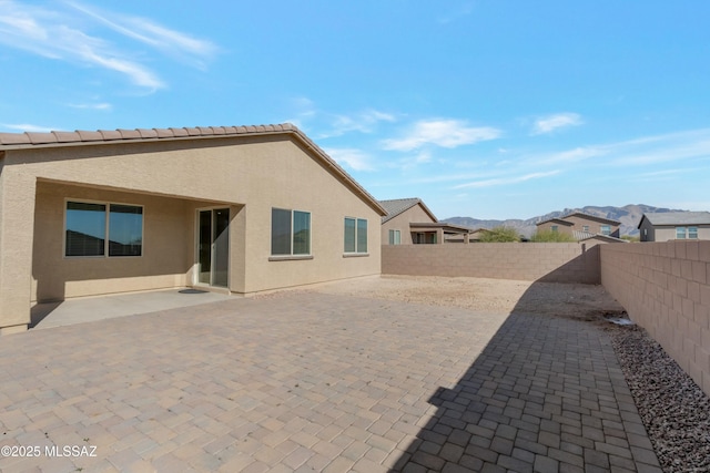 rear view of property with a patio area and a mountain view