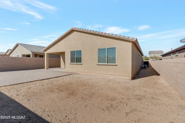 rear view of house with cooling unit and a patio area